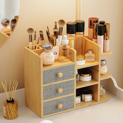 Bamboo makeup organizer with drawers and cosmetics.