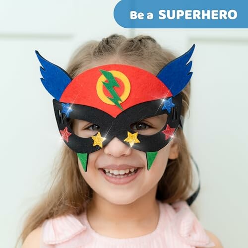 Child wearing a colorful superhero mask and smiling.