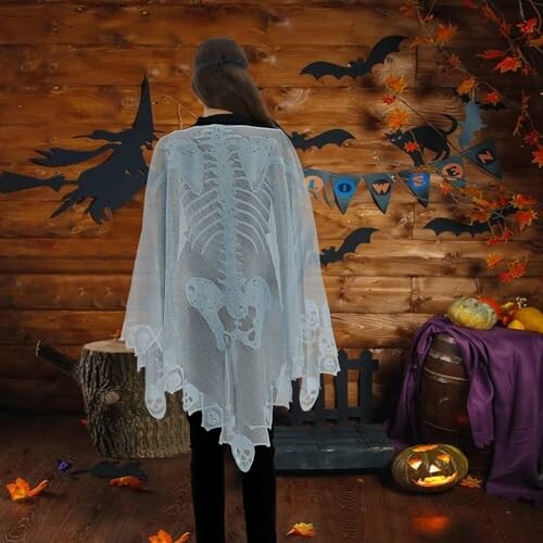 Person wearing a skeleton cape with Halloween decorations.